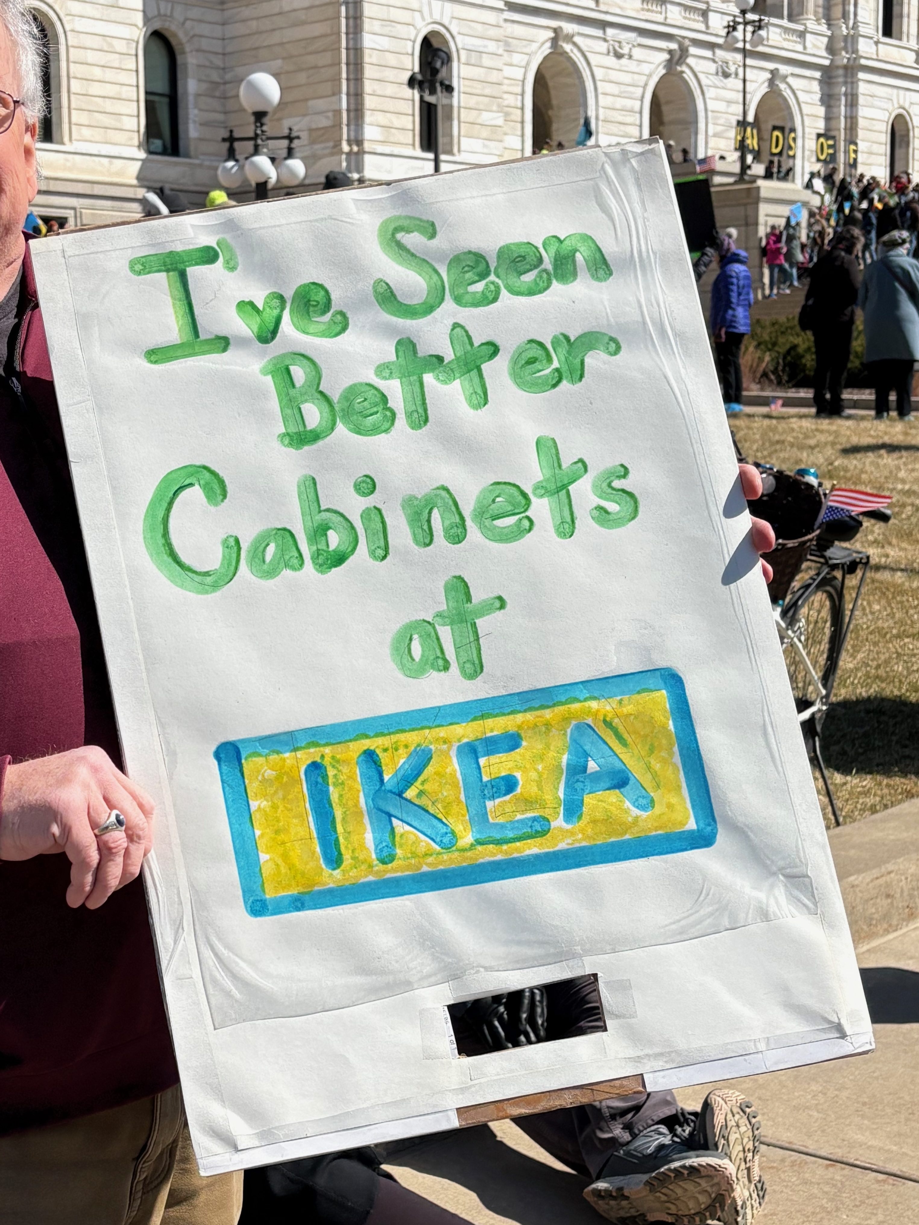 Protest sign: I've seen better cabinets at Ikea.