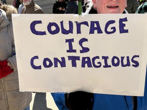 Protest sign: Courage is Contagious